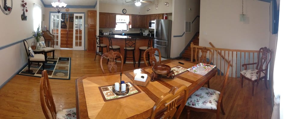 DINING ROOM; KITCHEN; STAIR LEADING TO ENTERTAINMENT ROOM