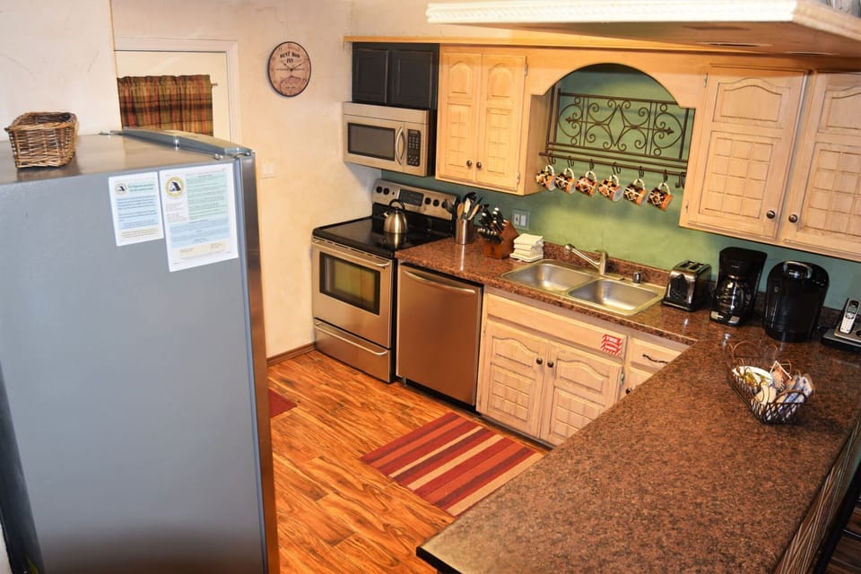 Your fully equipped kitchen awaits with stainless appliances, granite countertops, and a coffee maker ready for leisurely mornings. Cook, gather, and feel right at home in this warm, inviting space.