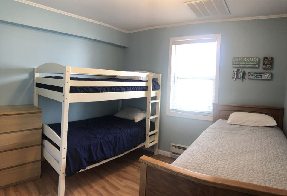 Bedroom 2 has twin bunk beds and a second twin bed