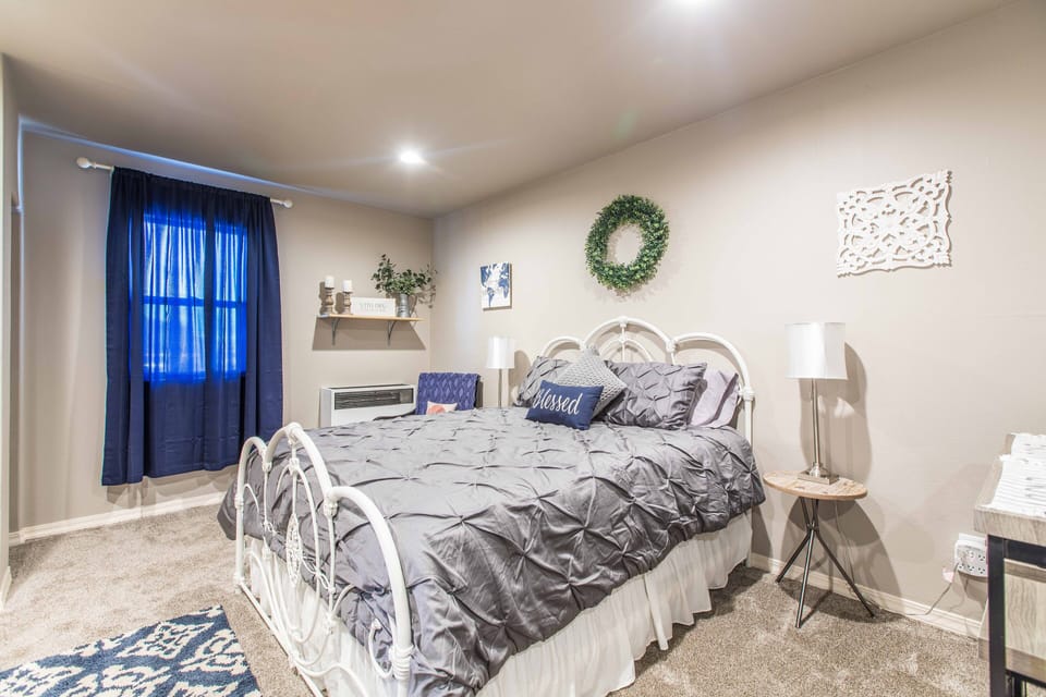 New queen bed with nightstands and lamps on both sides