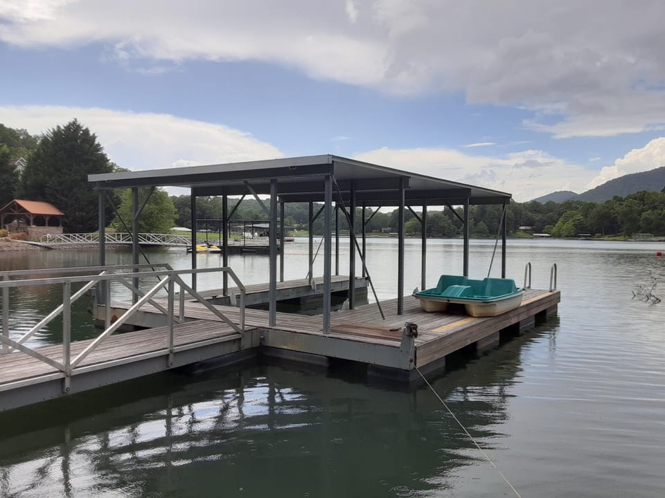 Private covered dock w/ single boat slip and side swim deck w/ ladder