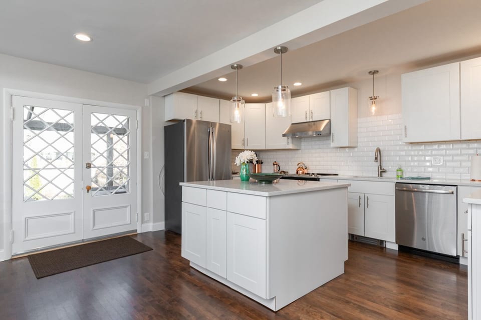 Beautiful open chef's kitchen. French doors to covered patio and grill.