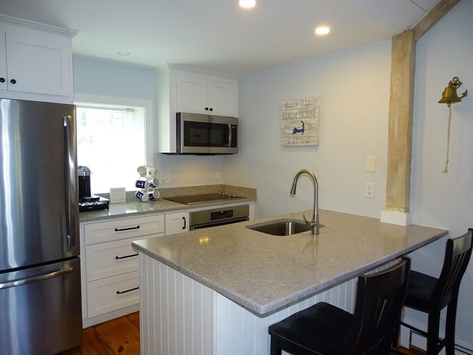 Kitchen with new stainless steel appliances, breakfast bar