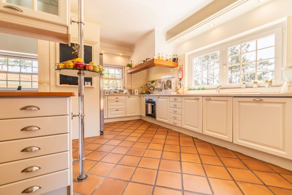 Spacious cream kitchen with terracotta floor tiles — Villa Gerbera, holiday villa in Herdade de Aroeira