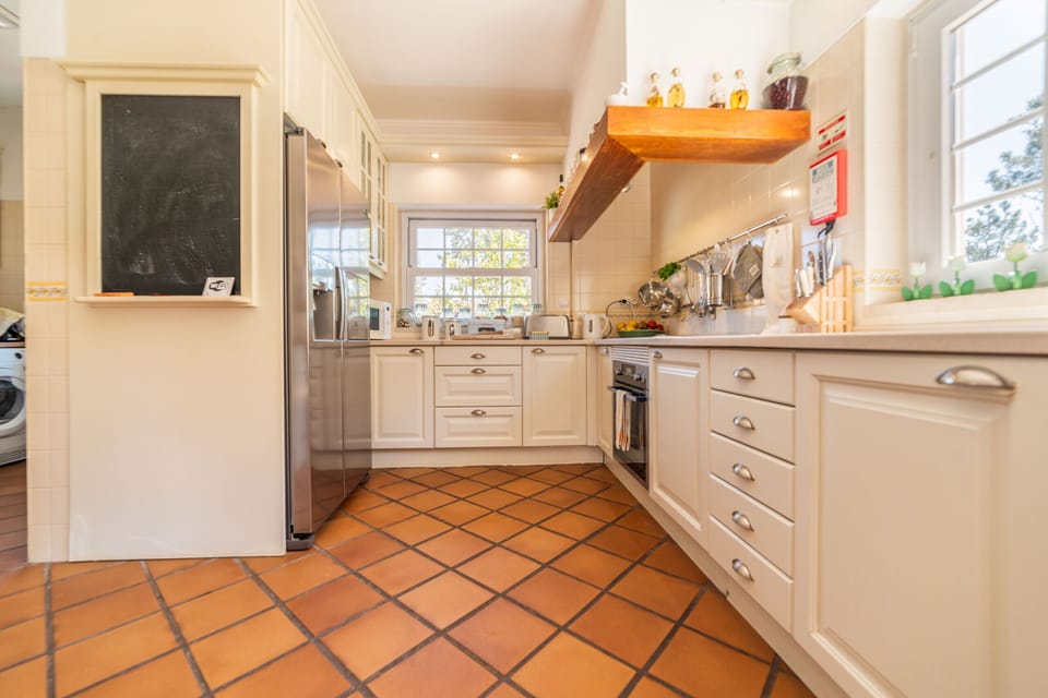 Spacious cream kitchen with terracotta tile flooring — Villa Gerbera, holiday villa in Herdade de Aroeira