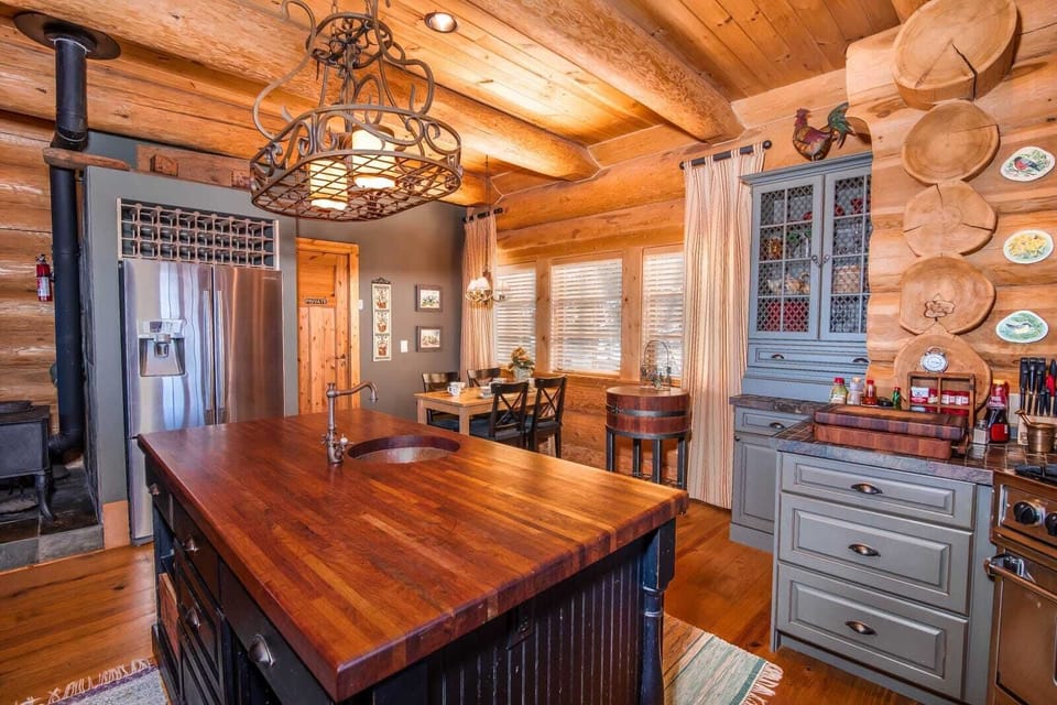 Stainless steel appliances and breakfast table with seating for 4