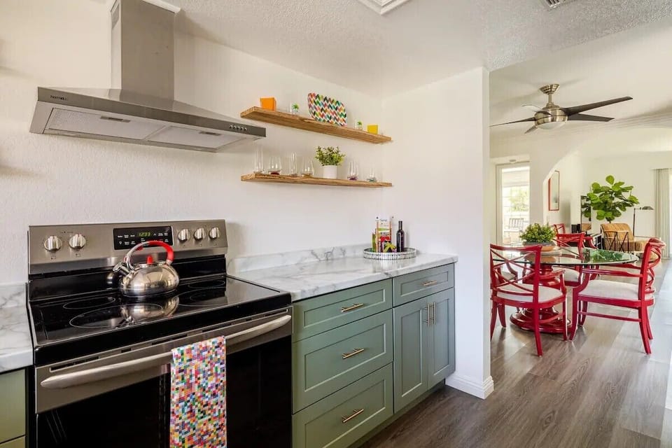- Modern kitchen layout with full-size oven, stove, and bright open view   - Easy access to dining and living areas for smooth meal prep flow   - Designed for comfort with practical space and contemporary style