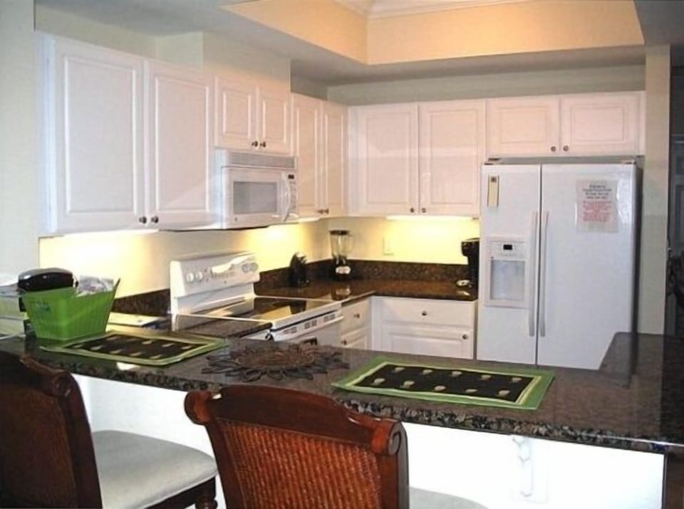 Kitchen with granite countertops; seats 2 at the bar and 4 at the dining table