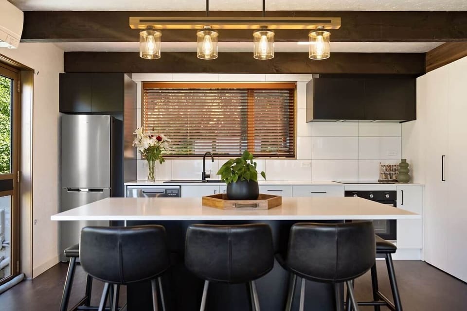 Kitchen with stone benchtop at Walk to Town 39A Alpine Chalet Queenstown