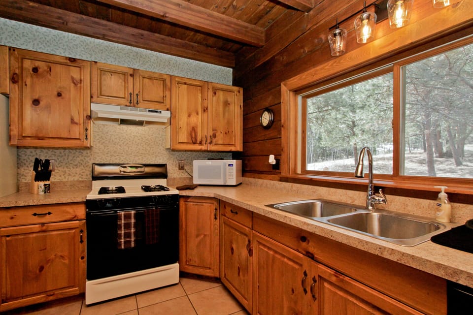 The kitchen is fully stocked with essential spices, condiments, and cookware