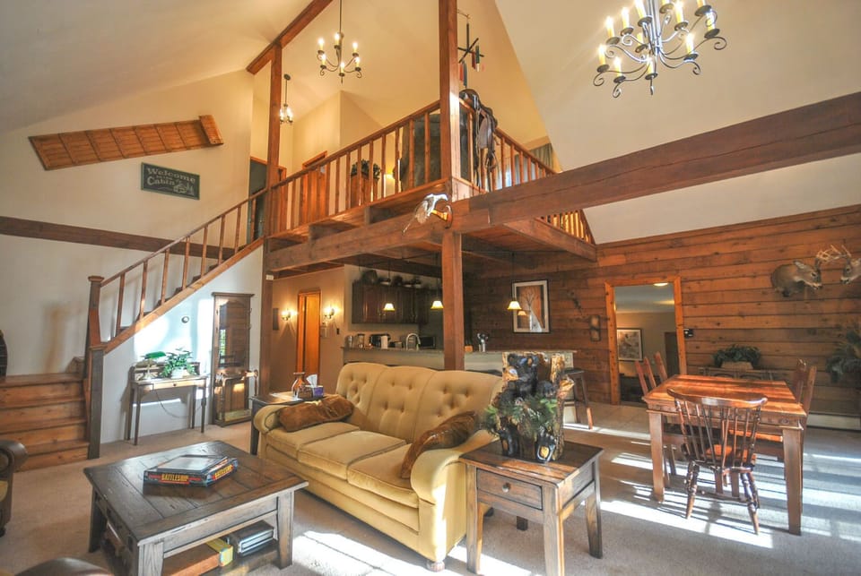 Living Room - Main Level. Spacious and high ceiling living area with comfy couches and chairs.