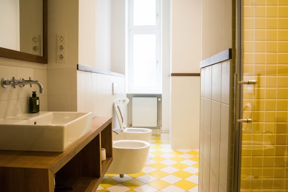 The yellow bathroom: italian tiles and walnut furniture and details