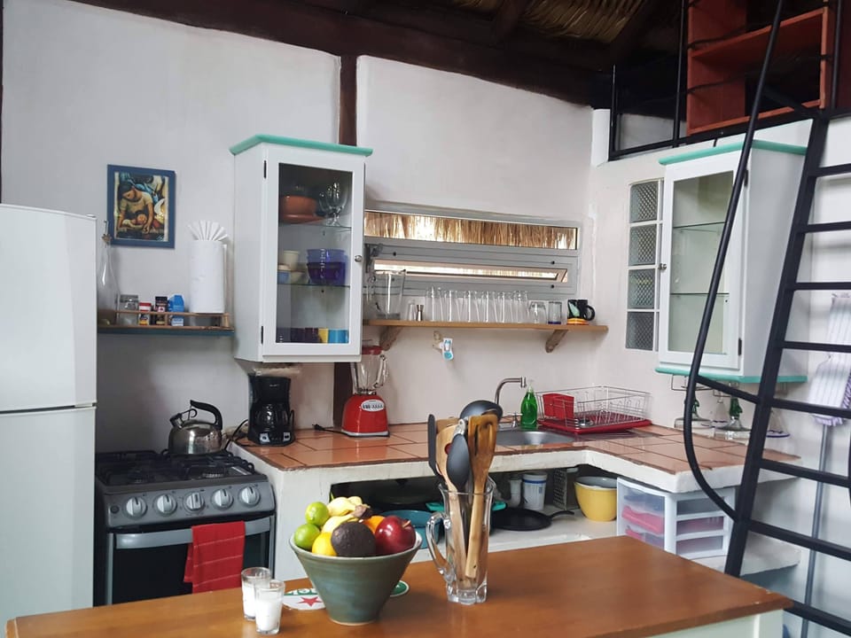 Kitchen view shows blender, coffee maker and tea kettle