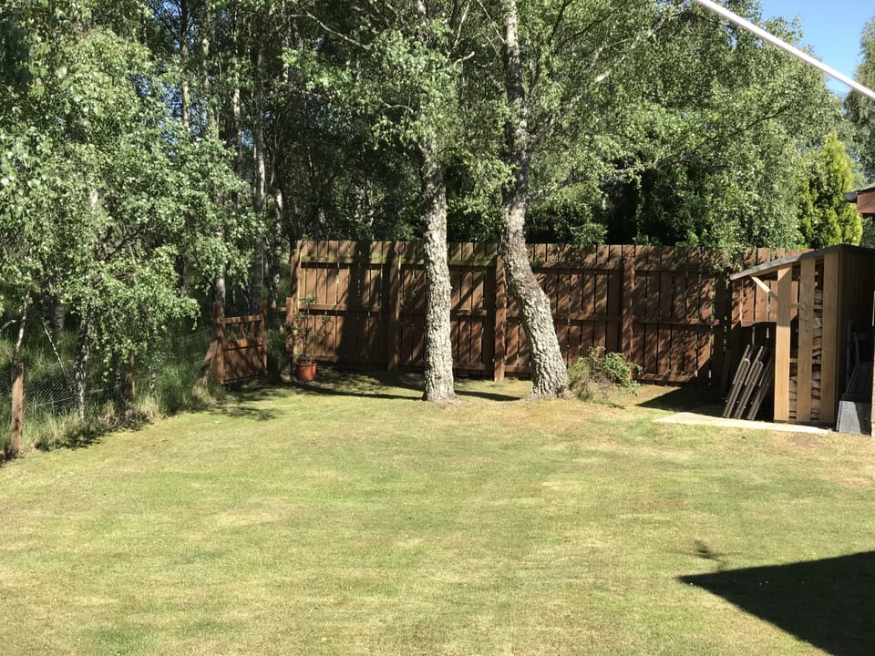 Large flat garden with table and chairs. 