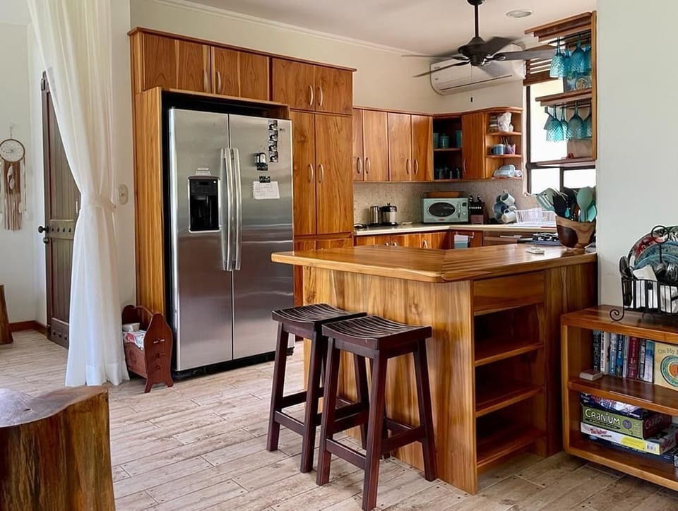 To the right of the alcove is the kitchen with teak cabinets.