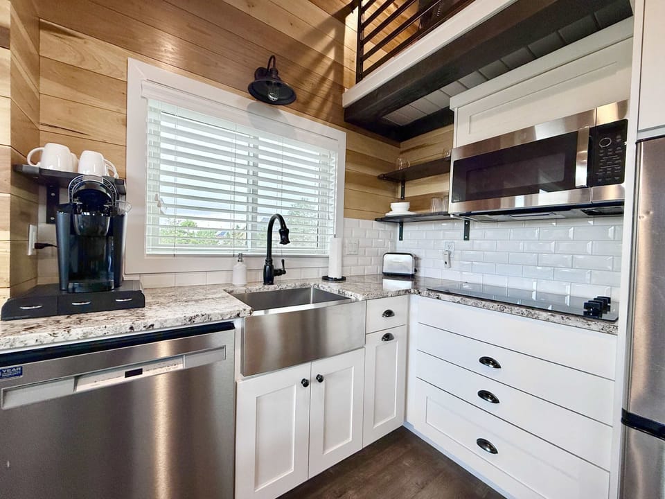 The kitchen includes everything you need to prepare your go-to meals, including a convection microwave oven for cooking and baking, a stovetop, a large fridge, and a Keurig coffee machine.