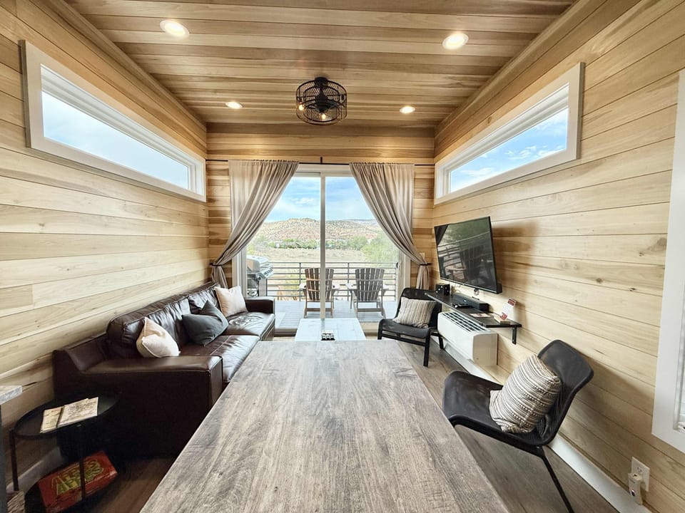 How big is 400 square feet? Bigger than you imagine! The living room in this tiny home is cozy and inviting, with plenty of seating for everyone to relax and socialize. At night, you can open the sofa up to have a queen-size sleeper.