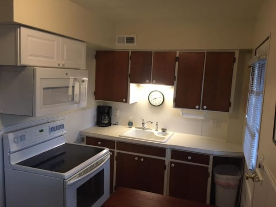 Full kitchen with coffee maker, toaster, disposal, sink stove and microwave.