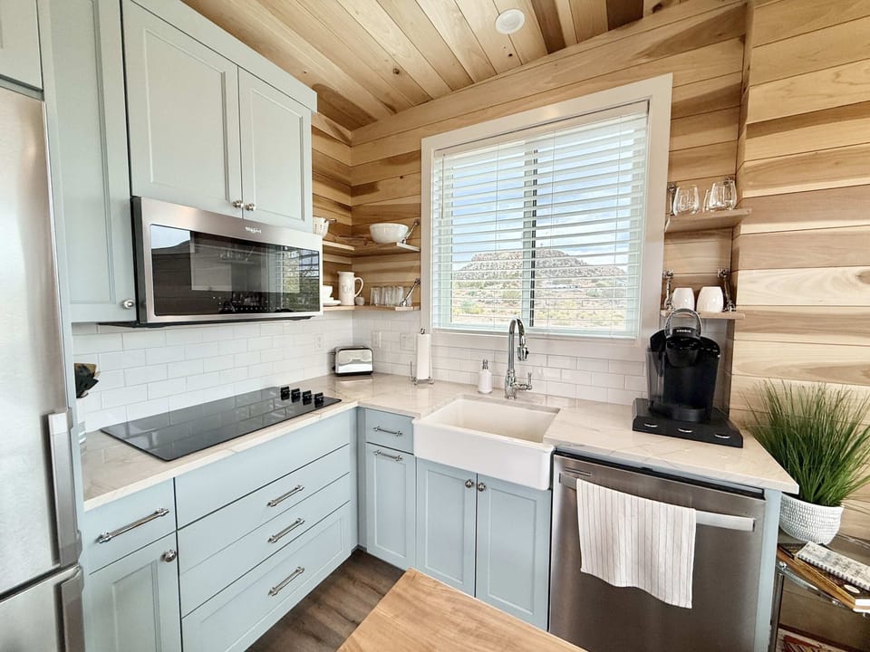 Who doesn’t love a farmhouse sink? You also have a fridge, stovetop, convection microwave oven and a coffee maker.