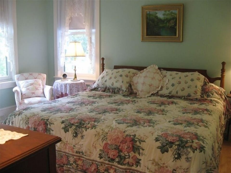 Green Bedroom: king bed, half bathroom, ceiling fan, closet, dresser