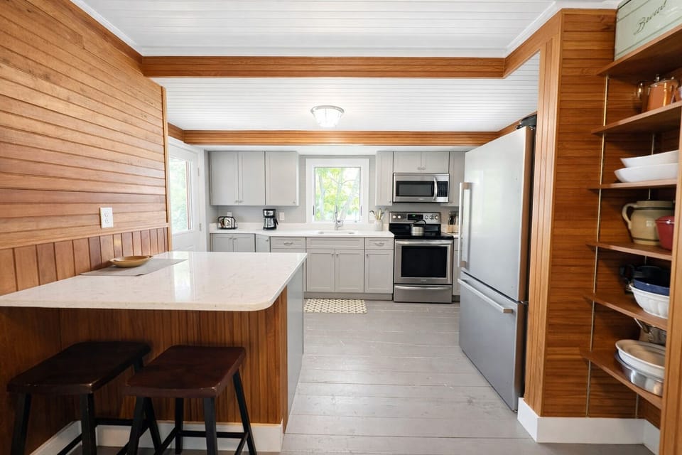 Well-equipped open kitchen area with island.