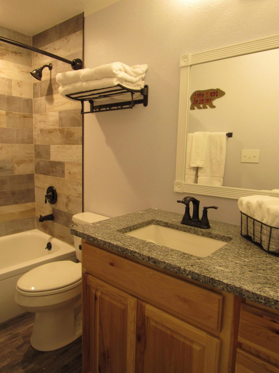 Bathroom with tall toilet, extra counter space, large mirror.