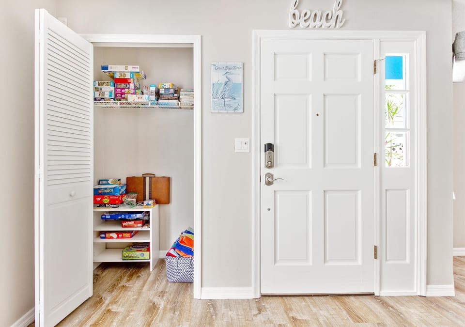 Closet beside the front door has beach/pool towels, games, puzzles, and books
