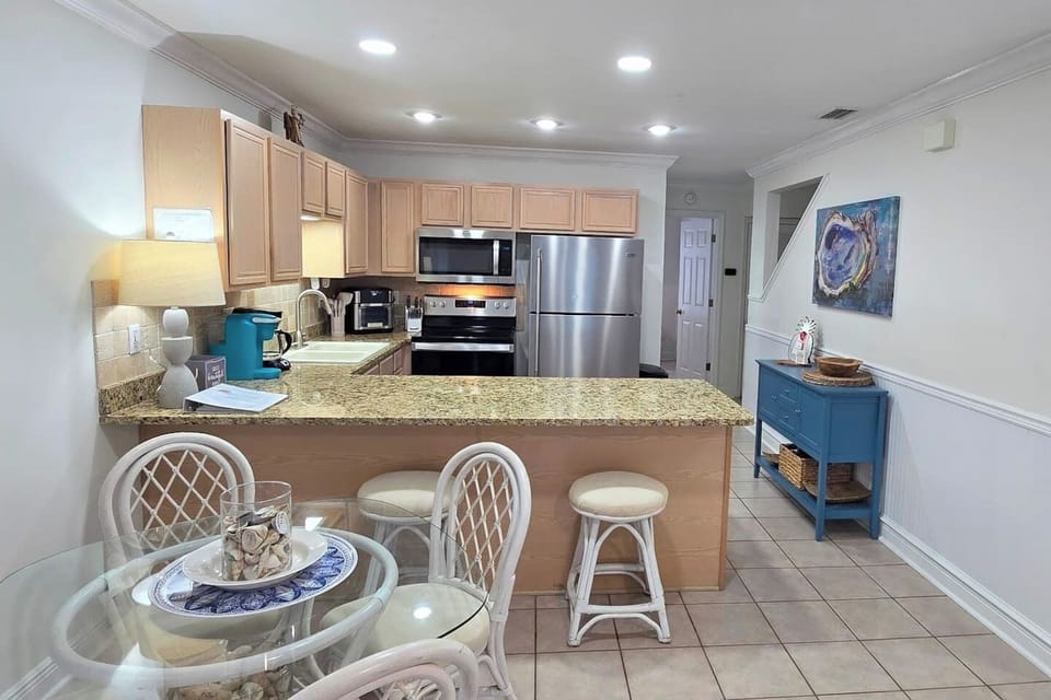 Pull up to the breakfast bar with your coffee while someone else cooks — the dining area keeps the group together from first meal to last.