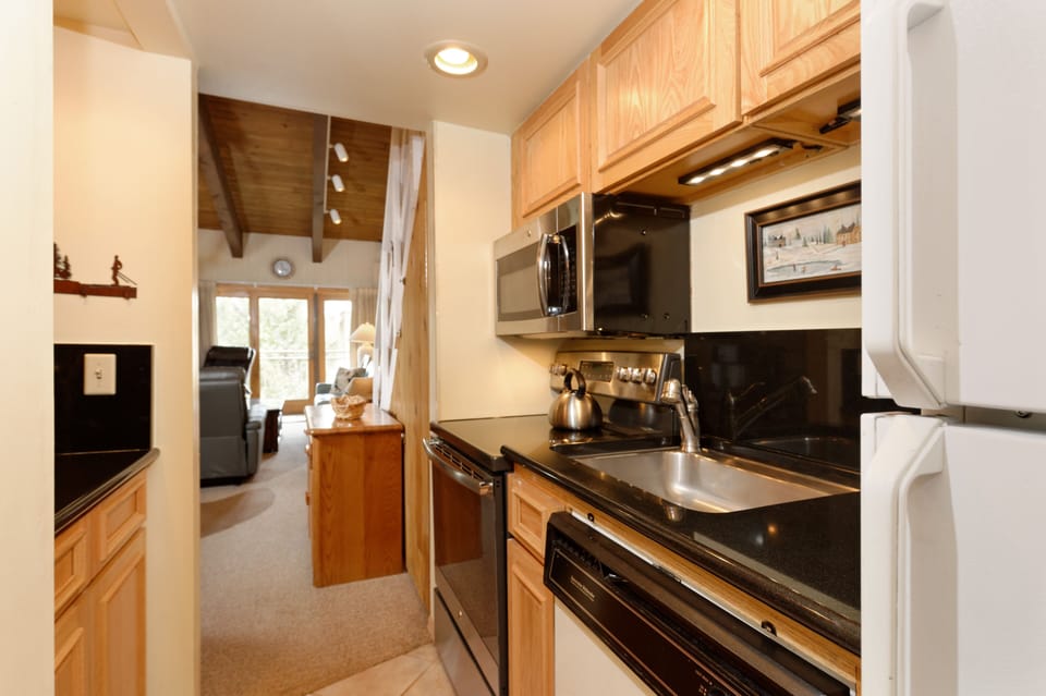 Full galley kitchen with full size appliances.