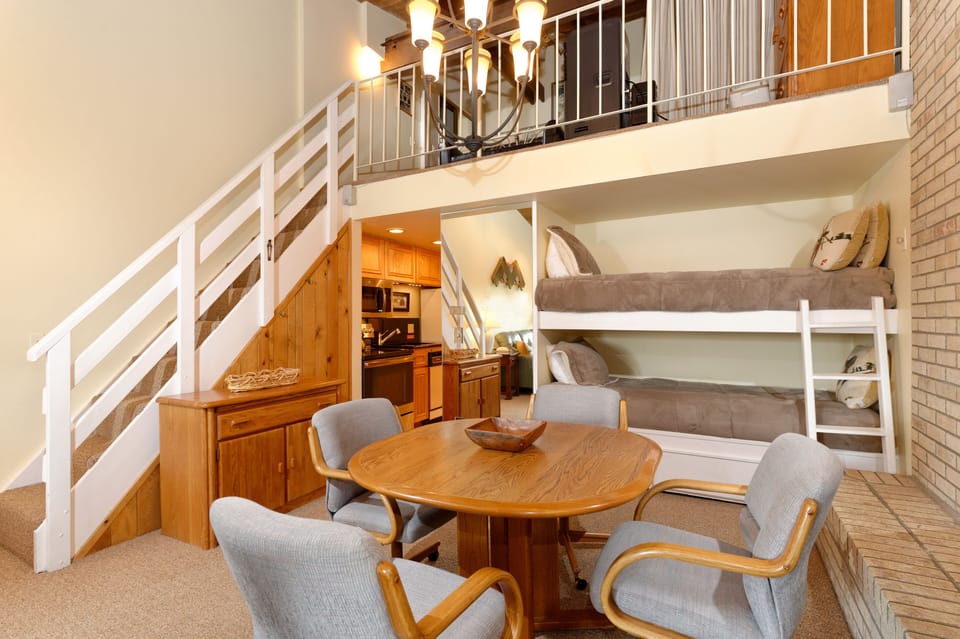 Bunk beds, dining area and stairs to loft.