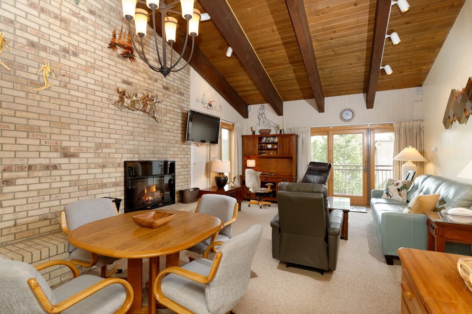 Living room with dining area and sleeper sofa.