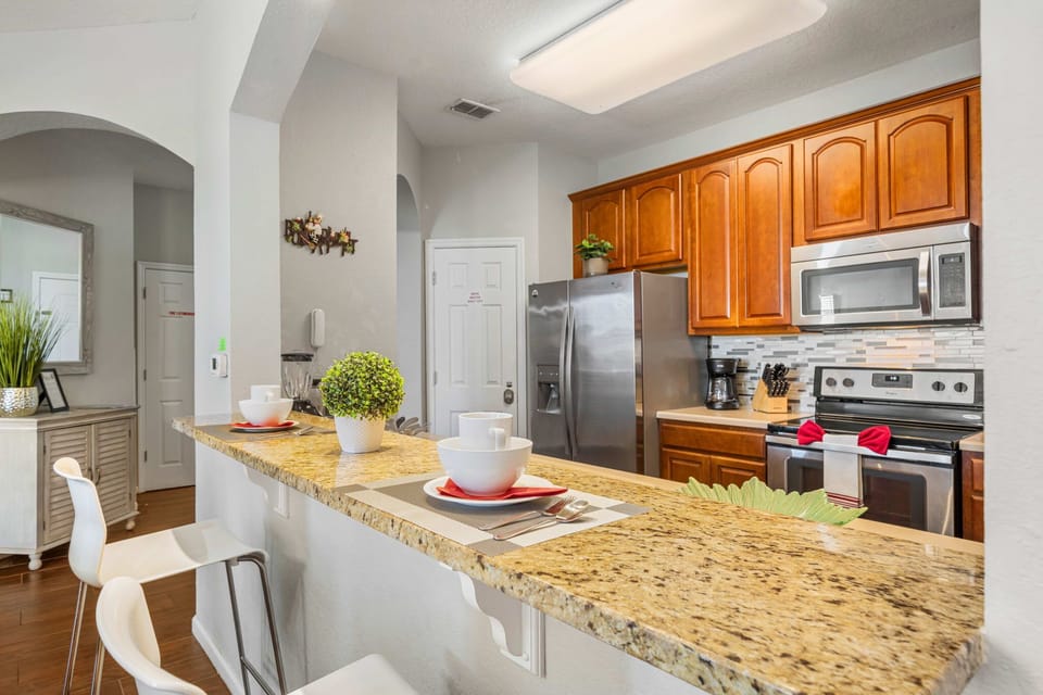 Cook with ease in the modern kitchen-granite breakfast bar for two, stainless appliances, and all the essentials for home-style meals.