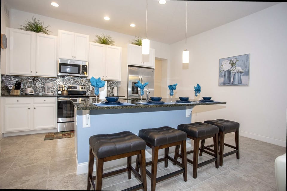 Fully-equipped modern kitchen with stainless steel appliances and a spacious island for family meals.