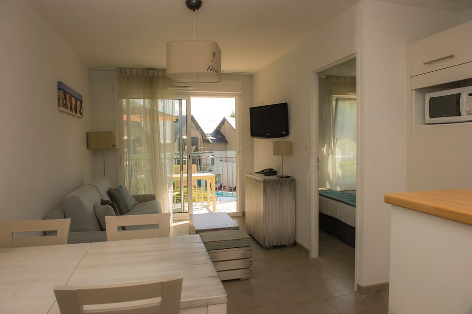 Prepare meals in the kitchenette and enjoy them at the dining table.