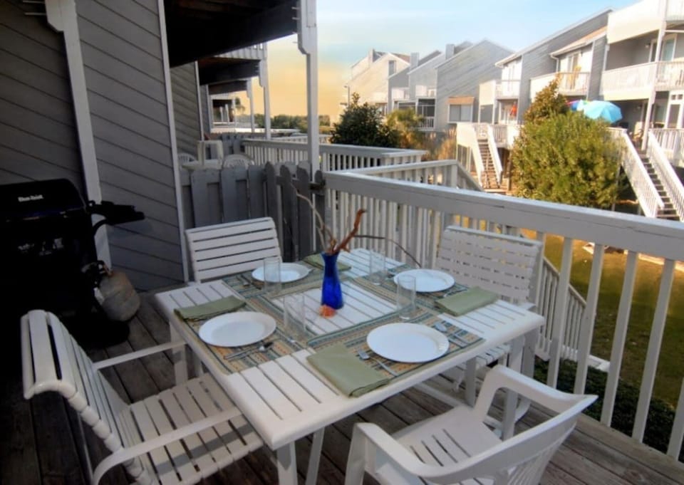 Pull up a chair on the upper deck and let the Gulf view do the rest — this is where dinner happens every night.