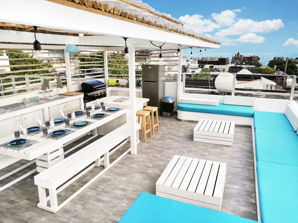Open concept kitchen and dining area on rooftop terrace.