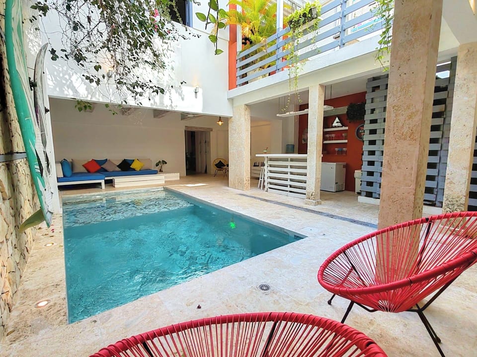 Private pool, next to living area, bar, and half bathroom.
