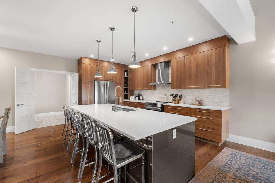 Spacious kitchen with gorgeous island and bar stools.