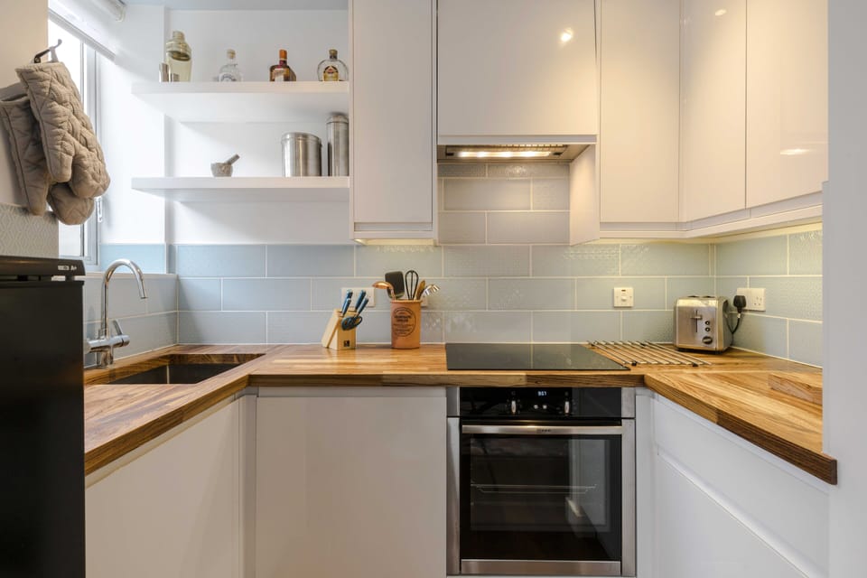 Fully stocked kitchen with clothes washing/drying machine. 