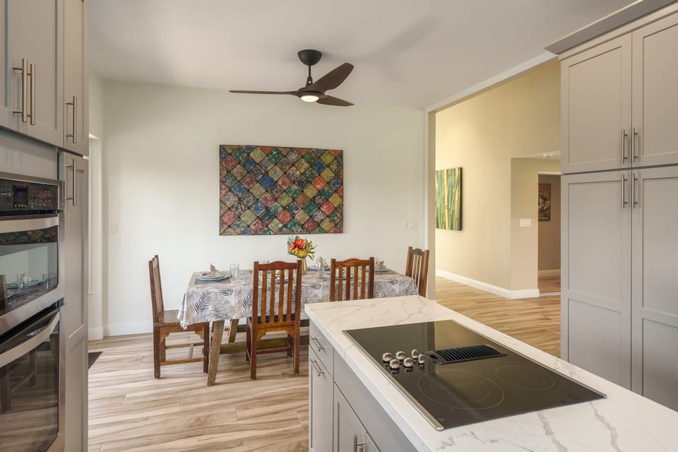 Gather around this elegant dining table with tropical-inspired decor and vibrant garden views, ideal for family dinners or special celebrations.