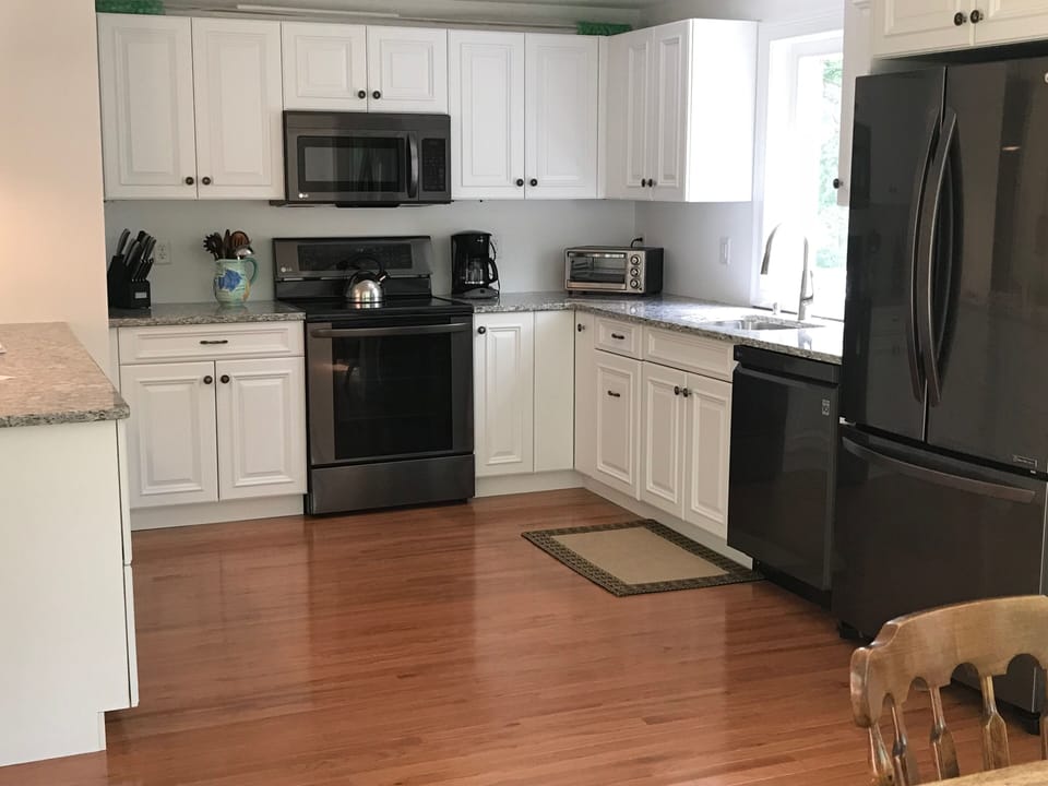 New wood floor, cabinets, & appliances! Includes dishes, pots, pans, plates, etc