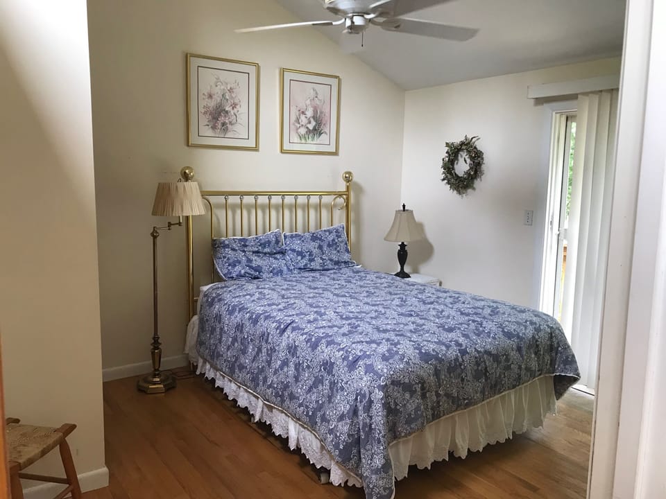 Queen sized bed on second floor of the house. The sliding door leads to balcony.