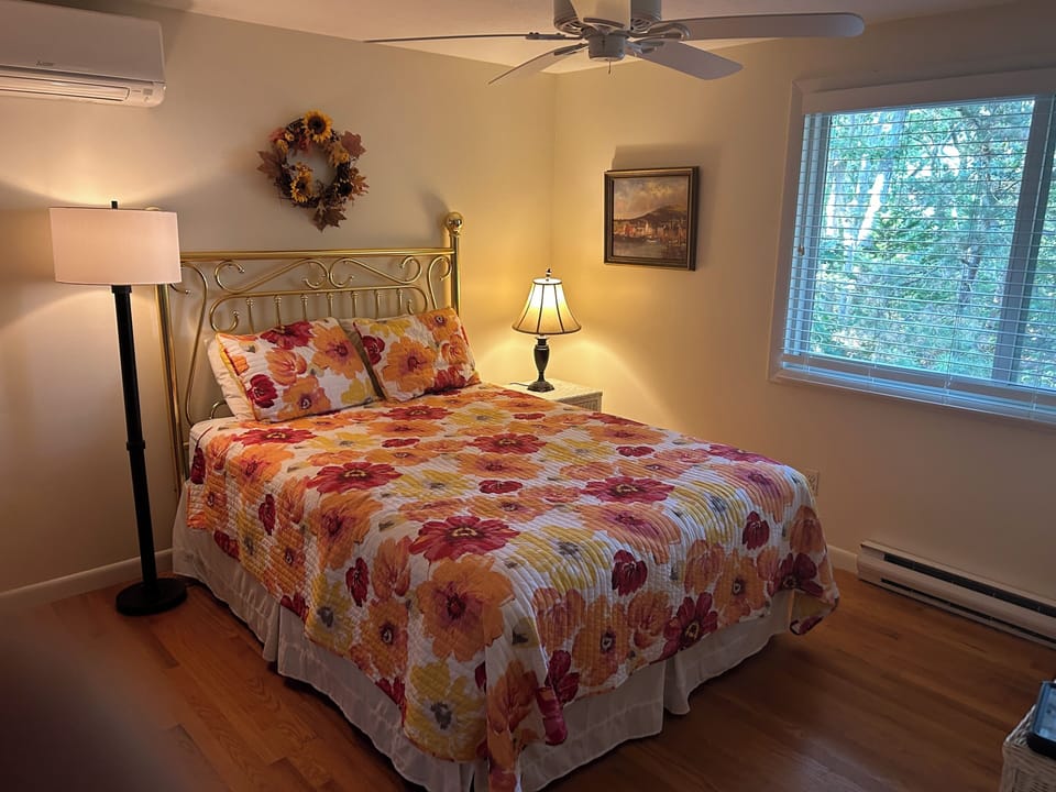 1st floor bedroom with queen-sized bed, dresser, mirror, closet. AC, ceiling fan