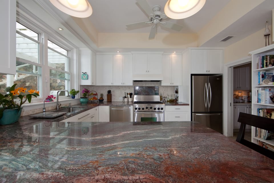 bright and airy gourmet kitchen with granite countertops