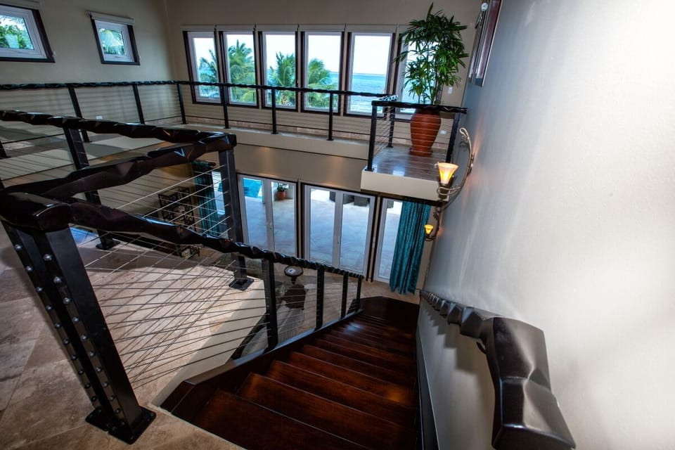 Stairway to upper livingroom and two king suites.