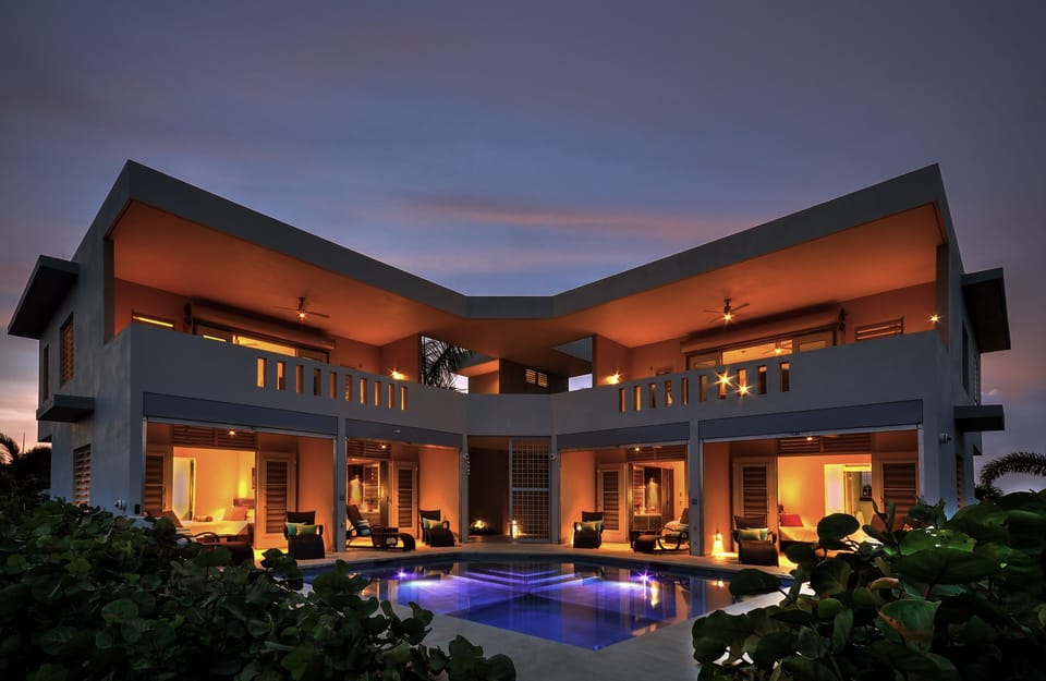 Four Private entrance bedroom suites surround pool.  Living above