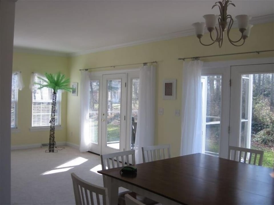 Table w/seating for eight and view of the backyard & pond