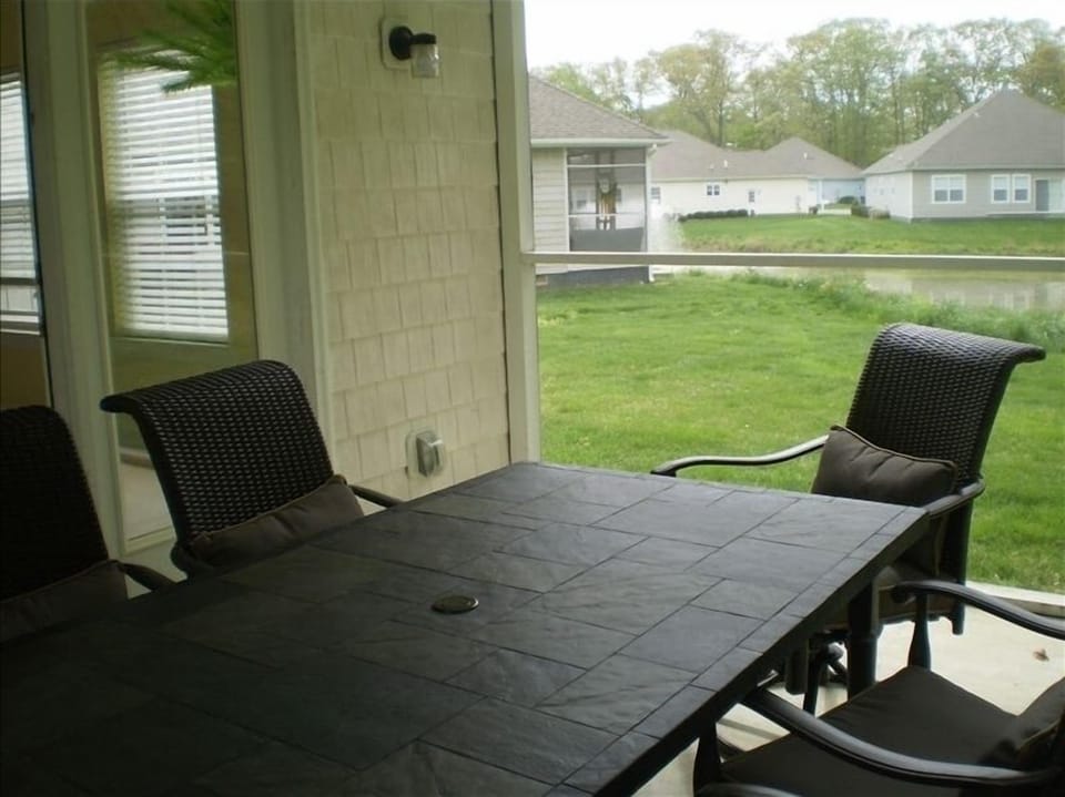 Screened in porch with seating for six and an excellent view of our pond