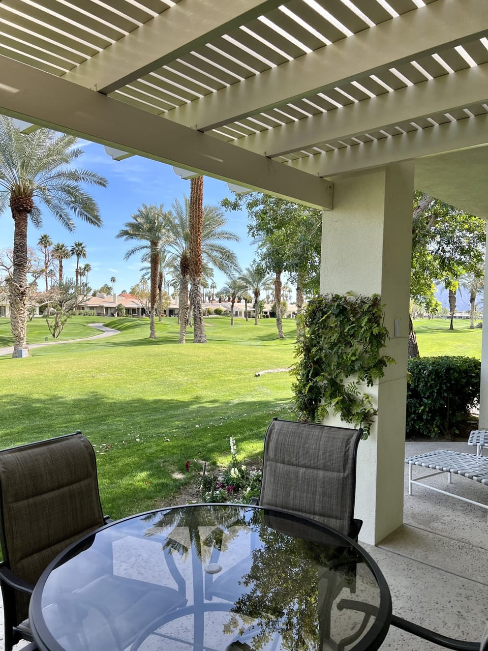 Covered back patio with view of 12th tee.  Fun to watch golfers tee off.