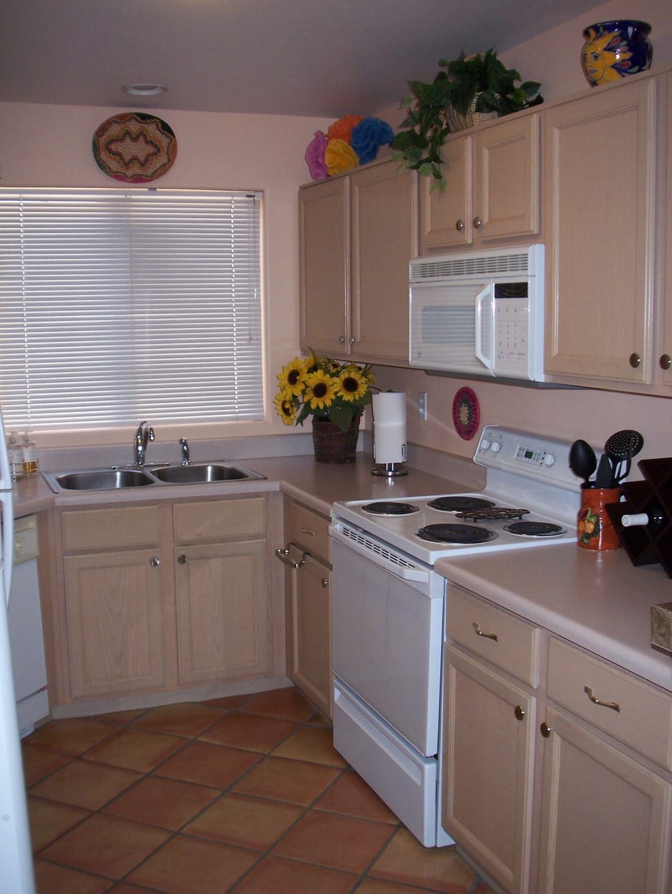 Kitchen has electric range, microwave, dishwasher, fridge/freezer, ice maker.